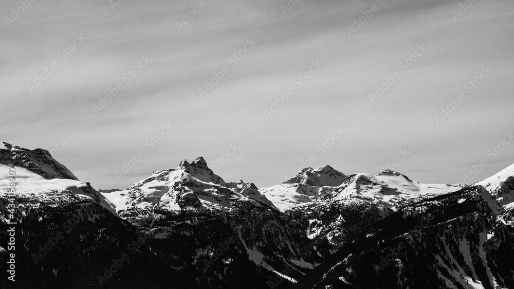 black and white snow-capped Columbia Mountains against the blue sky in British Columbia Canada