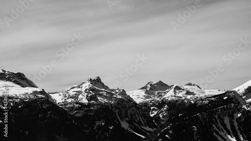 black and white snow-capped Columbia Mountains against the blue sky in British Columbia Canada