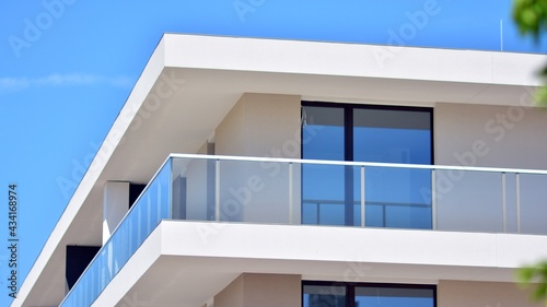 Condominium and apartment building with  symmetrical modern architecture. Detail in modern residential flat apartment building exterior. Fragment of new luxury house and home complex.  © Grand Warszawski