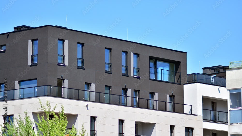 Condominium and apartment building with  symmetrical modern architecture. Detail in modern residential flat apartment building exterior. Fragment of new luxury house and home complex.