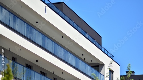 Condominium and apartment building with  symmetrical modern architecture. Detail in modern residential flat apartment building exterior. Fragment of new luxury house and home complex. © Grand Warszawski