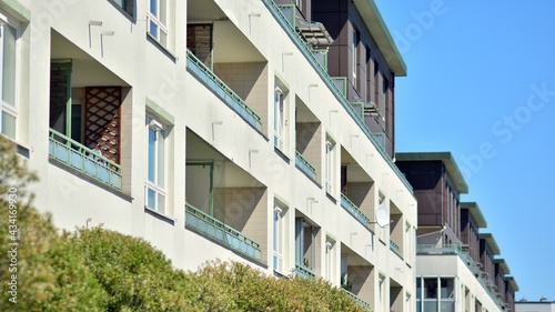 Condominium and apartment building with symmetrical modern architecture. Detail in modern residential flat apartment building exterior. Fragment of new luxury house and home complex.