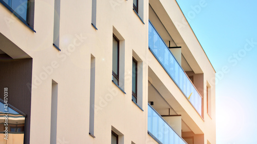 Apartment residential house and home facade architecture and outdoor facilities. Blue sky on the background. Sunlight in sunrise.