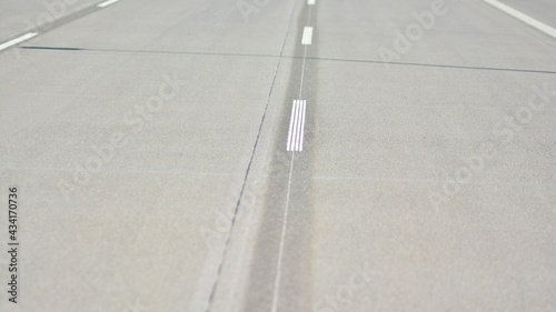 Straight modern concrete motorway with bright road marking. Transportation road system infrastructure. 