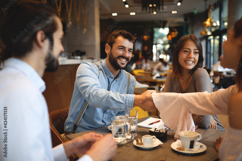 Group of young beautiful people hanging out in a cafe Group of young beautiful people hanging out in a cafe