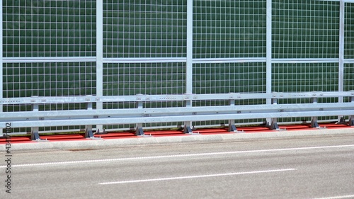 Safety barriers on the highway. Anodized safety steel barrier on freeway bridge.