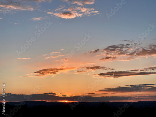 Sunset over some hills in the distance © Joe