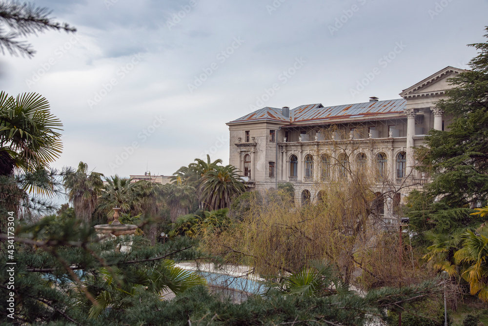 Obraz premium gray and gloomy abandoned sanatorium Ordzhonikidze in Sochi on cloudy day, Krasnodar Krai