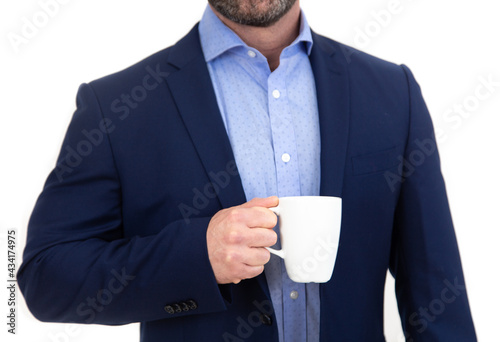 Man in blue blazer holding white coffee mug. White background.