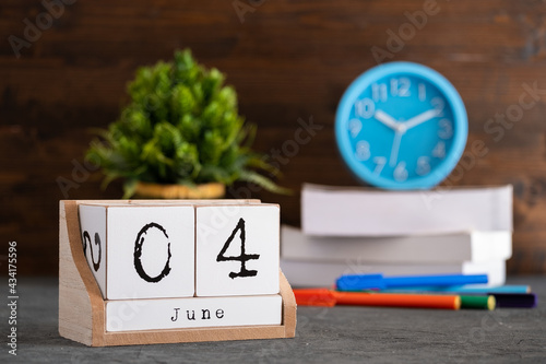 June 04th. June 04 wooden cube calendar with blur objects on background. photo