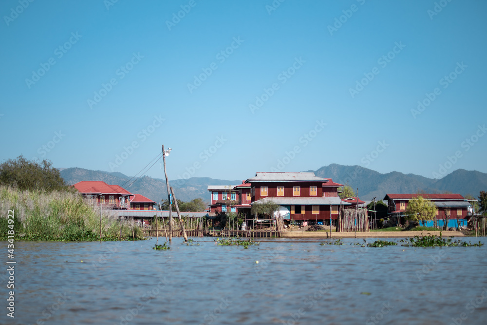 Buildings by the riverside at Inle Lake, Myanmar Buildings by the riverside at Inle Lake, Myanmar