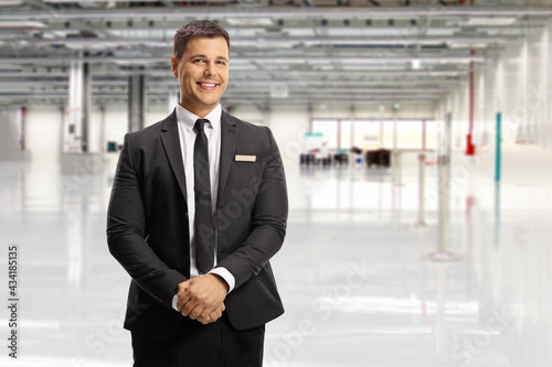 Fotografie, Obraz Airport official in a suit and tie posing