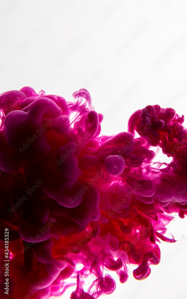 Ink drop in water. Abstract background. Pink background.