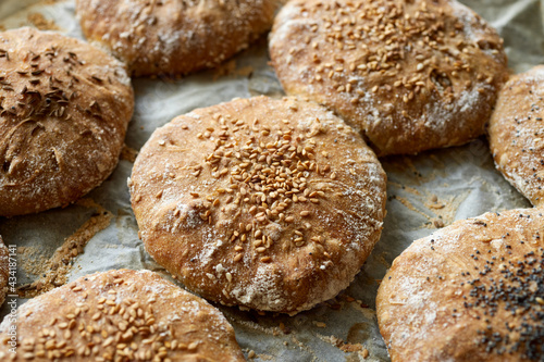 Homemade spelled flour bread with the addition of various seeds such as sesame, poppy seeds, caraway, close up view photo