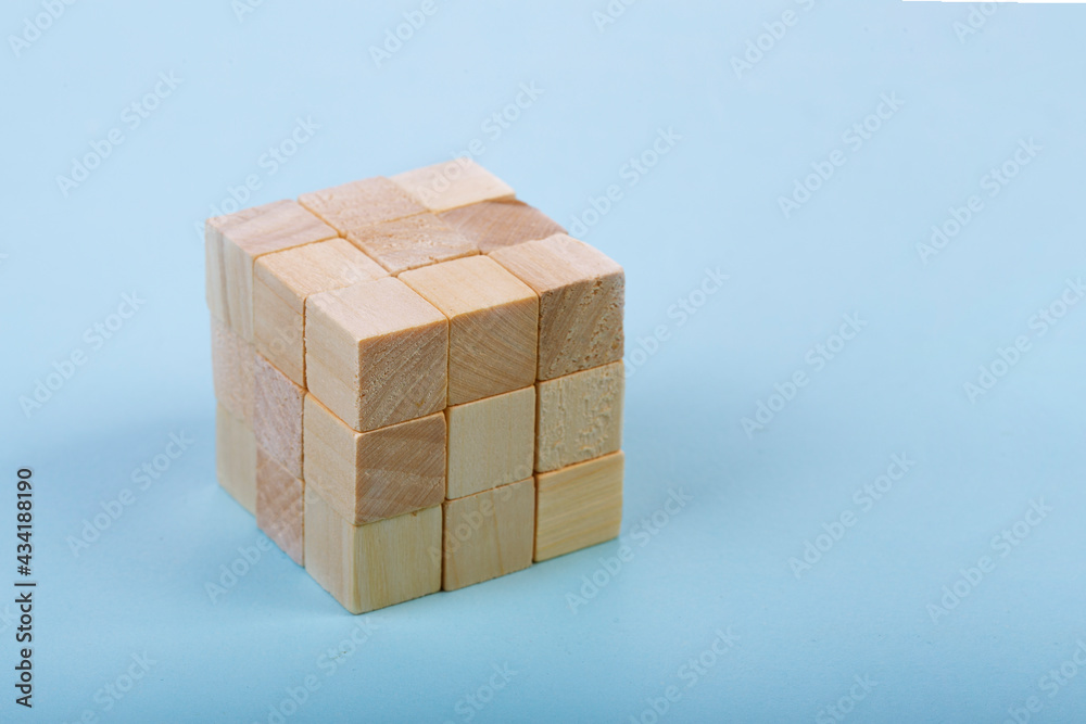 Obraz premium Wood Cube Block Construction on blue Background