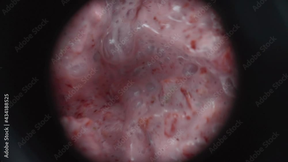 Close up of mixing fruit smoothie in blender, strawberries, milk and celery swirling in circle Close up of mixing fruit smoothie in blender, strawberries, milk and celery swirling in circle
