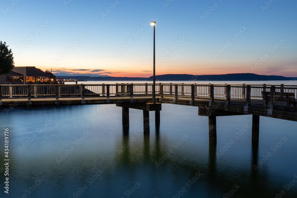 Street Light on Dock Over Water During Blue Hour