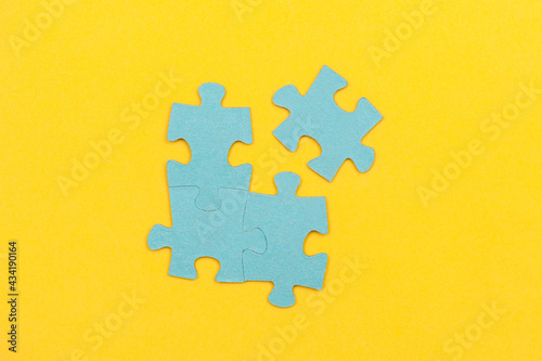 Blue puzzle pieces with a missing piece on a yellow background. Business concept