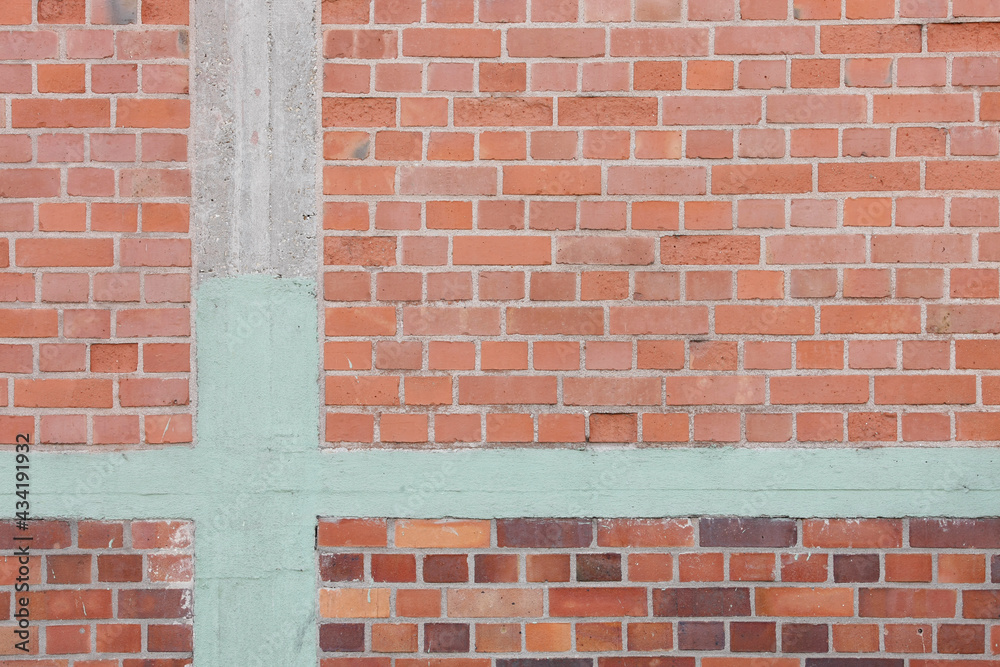 Red brown brick wall background with green painted stone wall, no person Red brown brick wall background with green painted stone wall, no person
