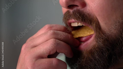 Man eating Tortillas chips in slow motion. Close-up