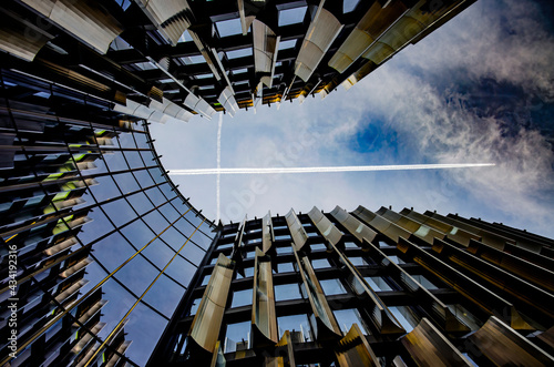 abstract business center with airplane crossing the sky