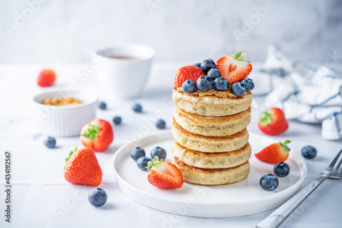 Banana pancakes with strawberries and blueberries