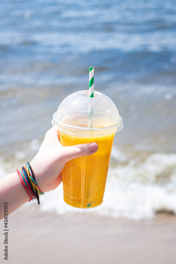 lemonade of the sea coast shore or orange fresh juice summer surf wave background refreshing drink relax positive mood vacation top view lemonade of the sea coast shore or orange fresh juice summer surf wave background refreshing drink relax positive mood vacation top view