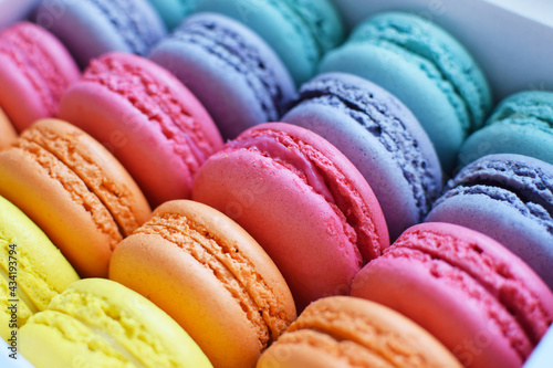 Multicolored  rainbow macaroon desserts. Delicious french macaroons with filling.