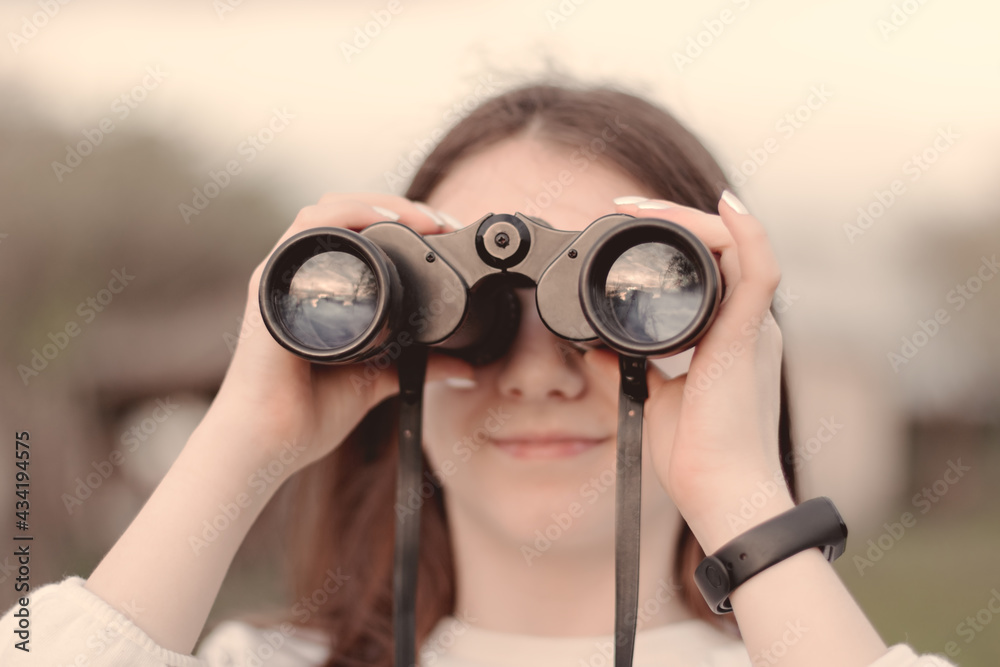 Selective focus to binoculars in the hand of girl. Selective focus to binoculars in the hand of girl.