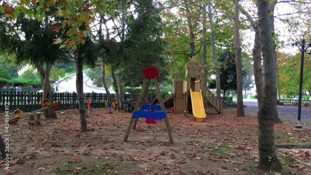 Child playground in autumn season with dry leaves on the ground. Due to pandemic, no kids are playing. Child playground in autumn season with dry leaves on the ground. Due to pandemic, no kids are playing.
