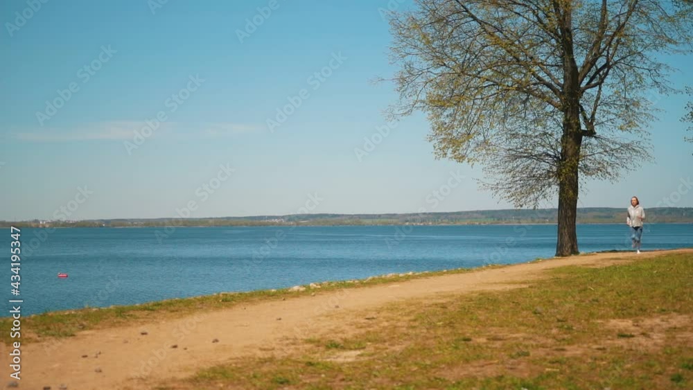 Young healthy woman jogging at the beach at sunny day. High quality FullHD footage Young healthy woman jogging at the beach at sunny day. High quality FullHD footage