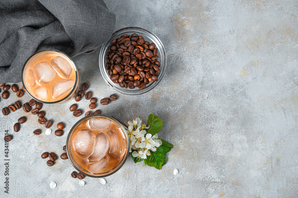 Iced coffee and coffee beans on a gray background. Iced coffee and coffee beans on a gray background.