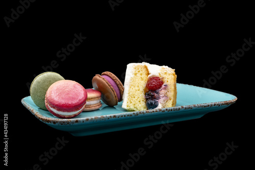 Macarons and fruit cake on a plate