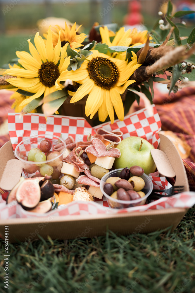 Picnic on a blanket with flowers on a farm 