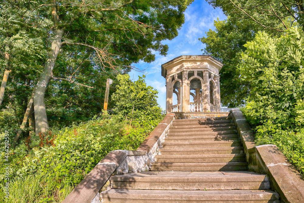 Stunning summer view of stairs leading to gazebo in Ternopil city park.
