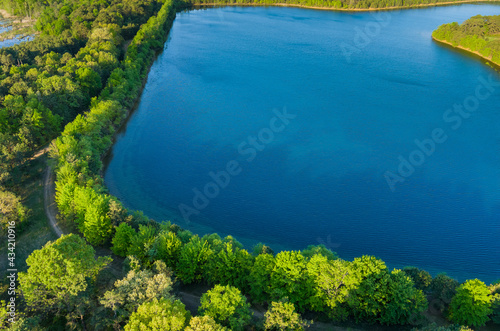 Aerial view of pond on a sunny summer day forest panorama © ungvar