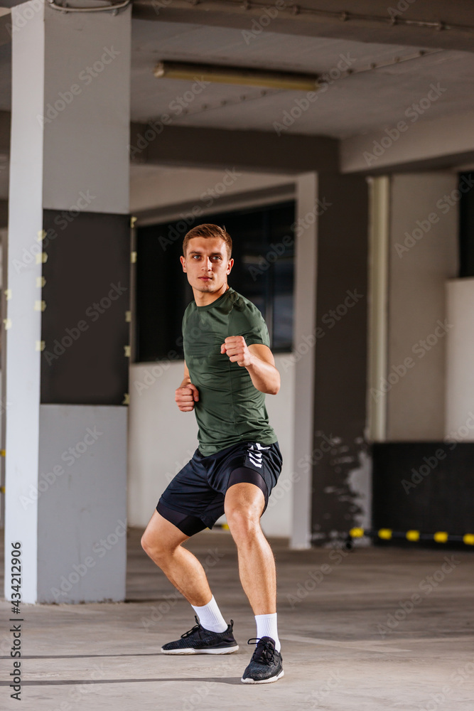 Obraz premium Fit sports man doing jump kick outdoors
