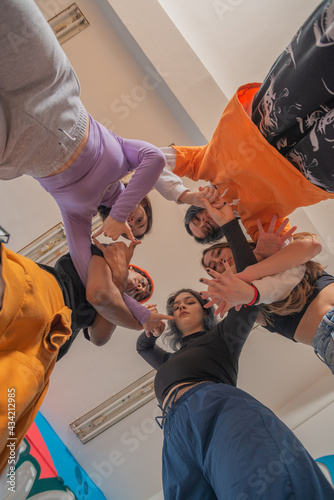 Group of hip hop dancers permorming their dance. Crew making show in an urban place photo