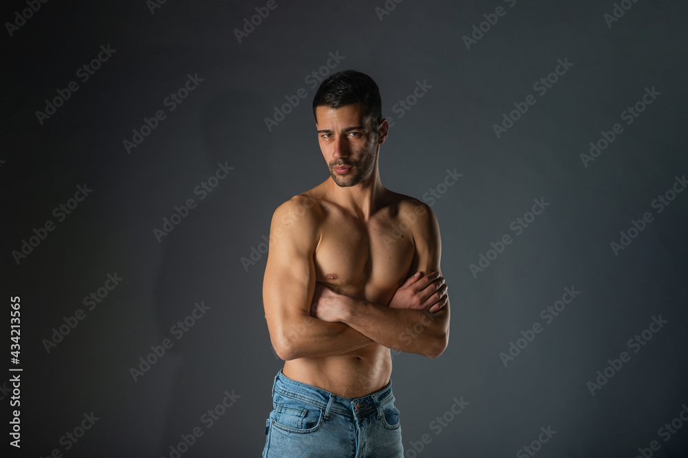 Portrait of an attractive stylish man posing against dark background