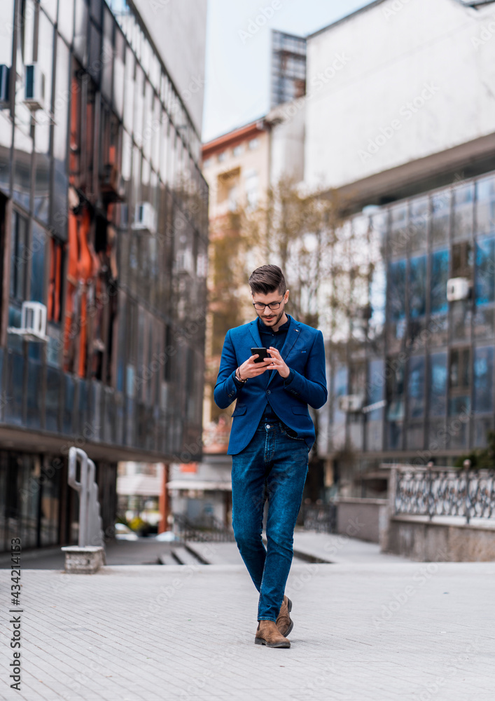 Fototapeta premium Stylish businessman watching in his smartphone