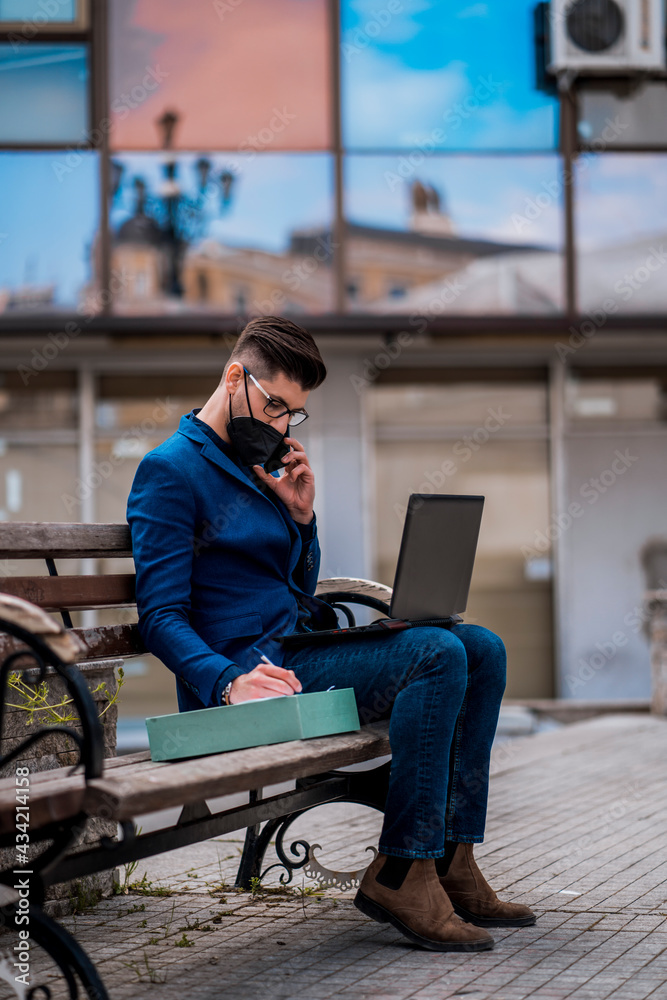 Young man talk on the mobile while sitting on bench Young man talk on the mobile while sitting on bench