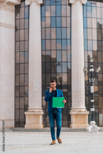 Modern businessman on mobile phone in urban place