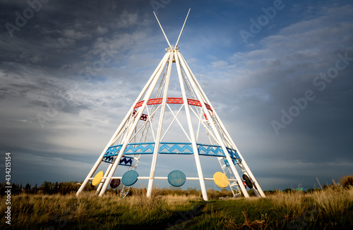 Medicine Hat Alberta Canada, May13 2021: The world's tallest tepee standing under a dramatic sky next to the Trans Canada Hiway in a Canadian city. photo