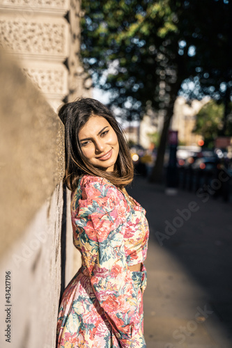 Portrait of a beautiful young woman outdoors in the city. Urban landscape. Travel and freelance lifestyle. Youth and beauty