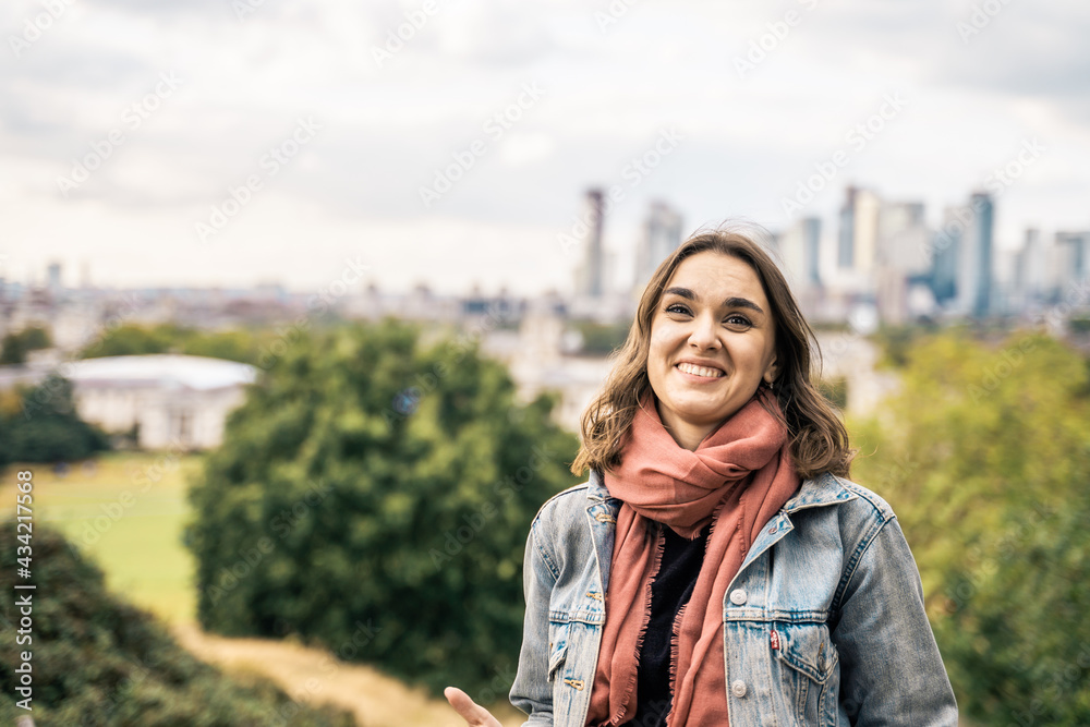 Portrait of a beautiful young woman outdoors in the city. Urban landscape. Travel and freelance lifestyle. Youth and beauty