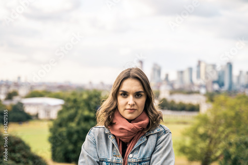 Portrait of a beautiful young woman outdoors in the city. Urban landscape. Travel and freelance lifestyle. Youth and beauty