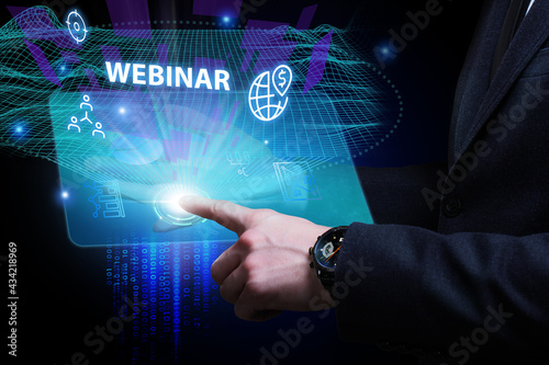 Business, Technology, Internet and network concept. Young businessman working on a virtual screen of the future and sees the inscription: Webinar