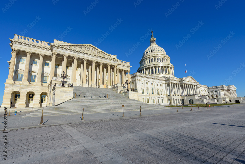 Wide angle view of United States Capitol  Building under blue sky, Washington DC