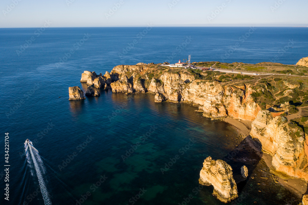 Ponta da Piedade lighthouse. Portuguese southern golden coast cliffs. Aerial view in Lagos in Algarve, Portugal.