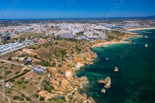 "Ponta da Piedade" - Portuguese southern golden coast cliffs. Aerial view over city of Lagos in Algarve, Portugal. © Miguel